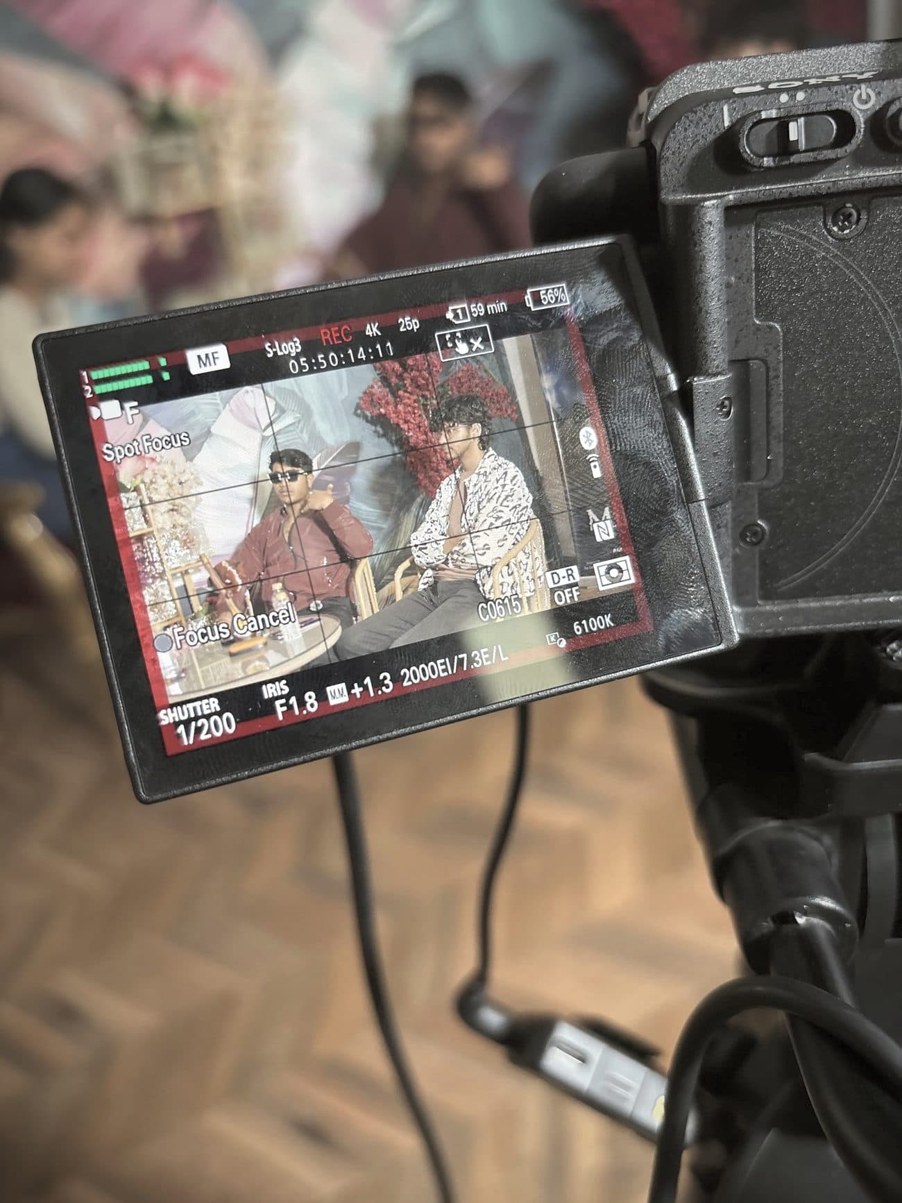 A Sony cinema camera monitoring a two-person scene on set